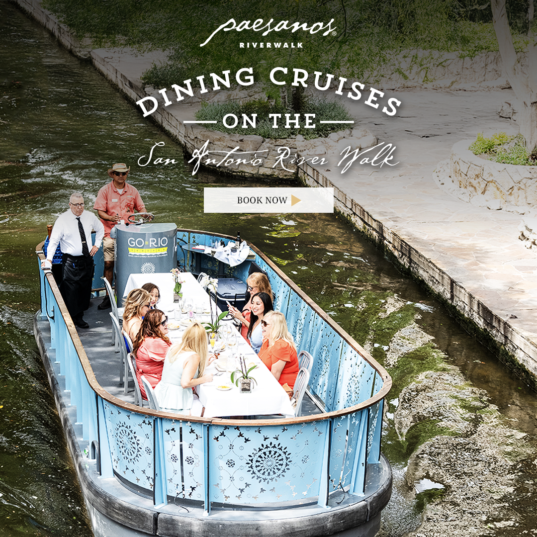 Promotional hero showing a riverboat dining cruise on the San Antonio River Walk with guests at a long table and a Book Now button (Paesanos).